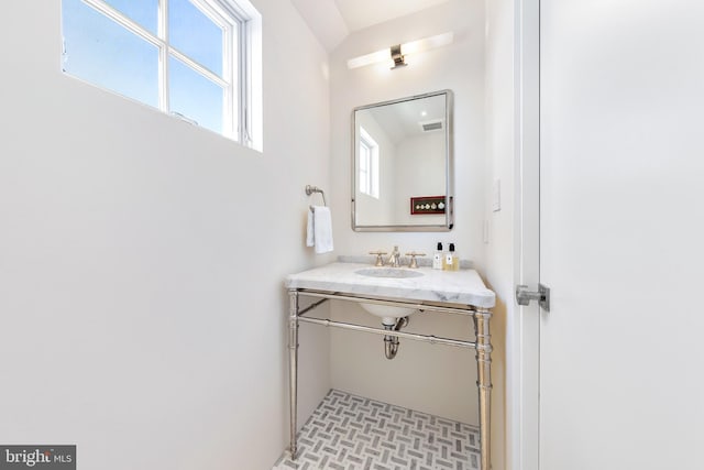 bathroom with sink and vaulted ceiling