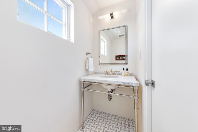 bathroom featuring visible vents and a sink