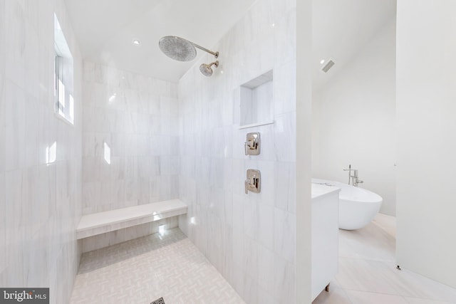 bathroom with tile patterned flooring, tile walls, plus walk in shower, and vaulted ceiling