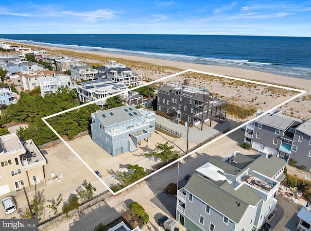drone / aerial view with a beach view and a water view