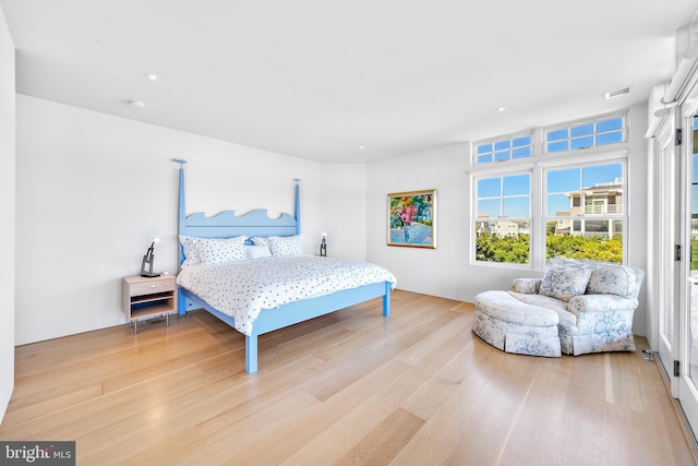bedroom with recessed lighting, visible vents, and wood finished floors
