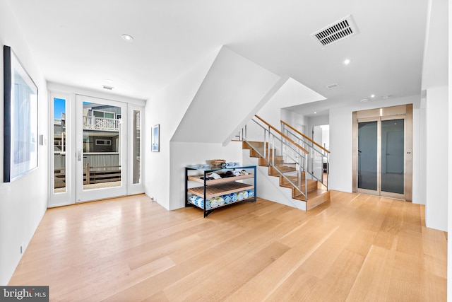 entryway featuring visible vents, stairway, wood finished floors, and recessed lighting