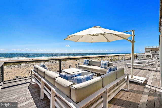 wooden deck featuring outdoor lounge area, a beach view, and a water view