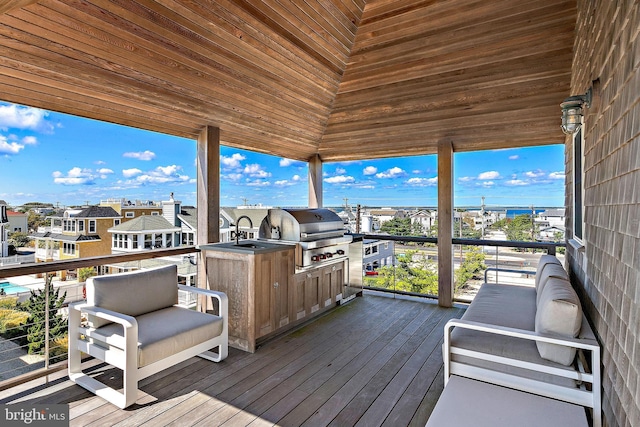 wooden deck with grilling area and a sink