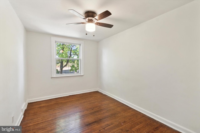 spare room with dark hardwood / wood-style floors and ceiling fan