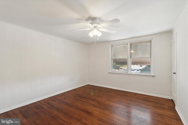 empty room with dark wood-type flooring and ceiling fan