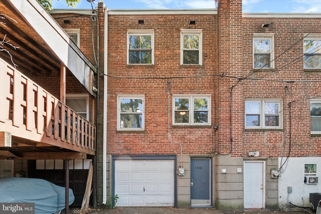 back of property featuring a garage