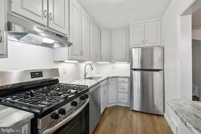 kitchen featuring appliances with stainless steel finishes, white cabinets, and sink