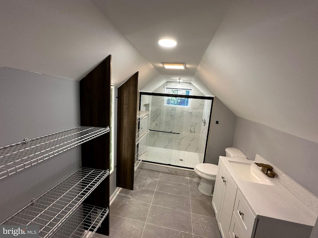 bathroom featuring tile patterned floors, walk in shower, vanity, toilet, and lofted ceiling