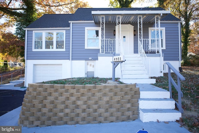 view of front of house with a porch and a garage