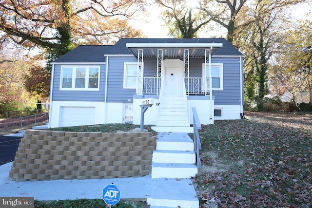 view of front of home featuring covered porch and a garage