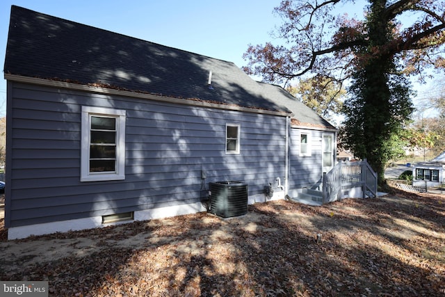 rear view of house with central AC unit and a deck