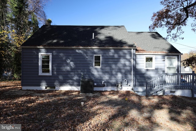 rear view of property with cooling unit