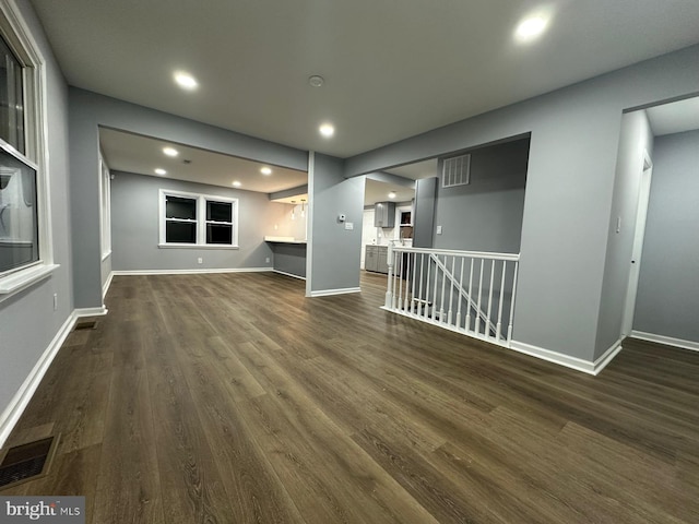 unfurnished living room featuring dark wood-type flooring