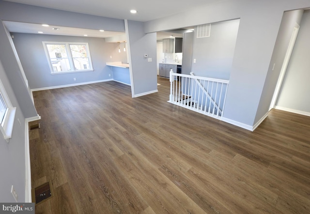 unfurnished living room with dark hardwood / wood-style floors