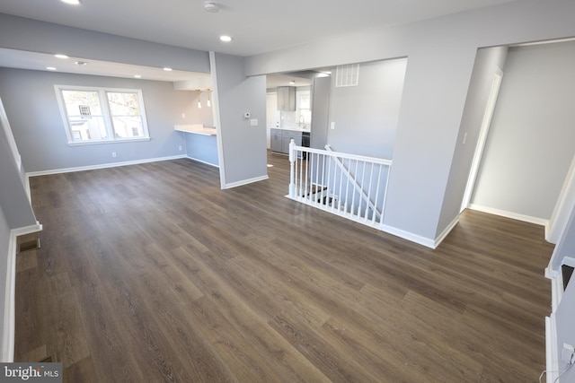 unfurnished living room featuring dark hardwood / wood-style floors