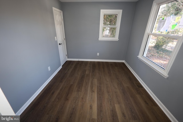 empty room with dark hardwood / wood-style floors