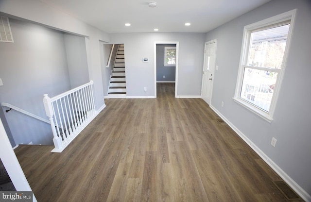 foyer entrance featuring plenty of natural light and dark hardwood / wood-style floors