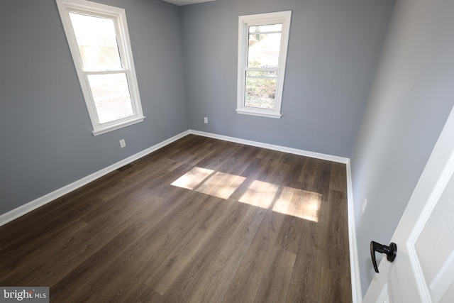 empty room with dark hardwood / wood-style floors