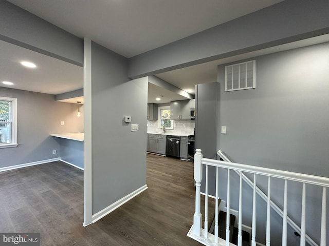 corridor with dark hardwood / wood-style flooring