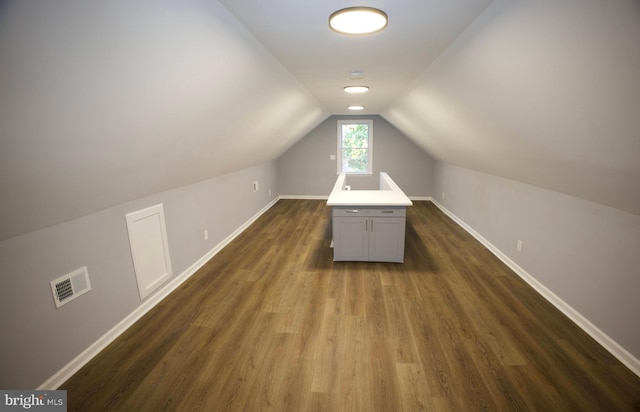 bonus room featuring dark hardwood / wood-style flooring and vaulted ceiling