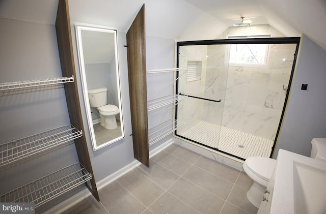 bathroom with toilet, tile patterned floors, vaulted ceiling, and a shower with door