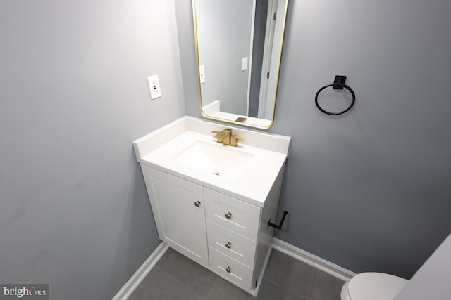 bathroom with tile patterned flooring, vanity, and toilet