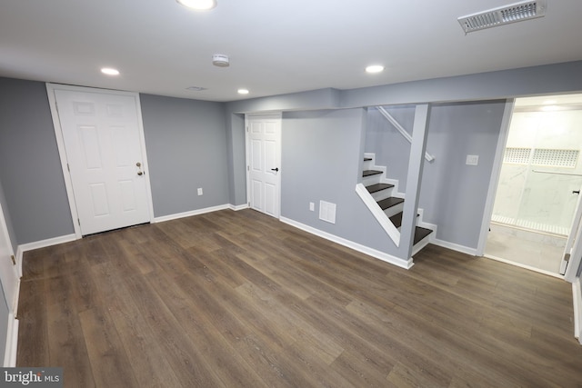 basement with dark hardwood / wood-style floors