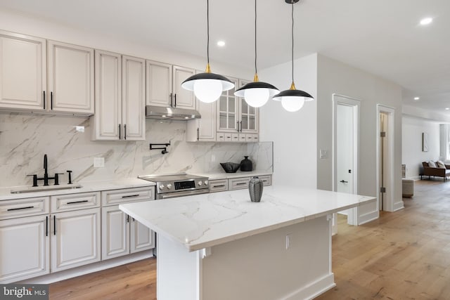 kitchen featuring white cabinets, light wood-type flooring, and backsplash