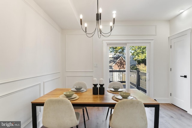 dining area featuring a chandelier and light hardwood / wood-style floors