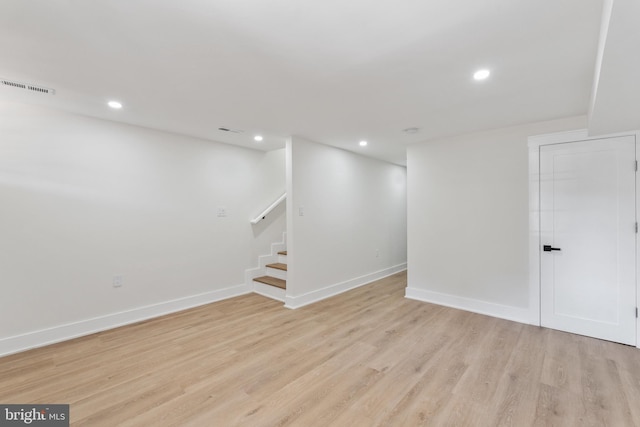 basement with light hardwood / wood-style floors