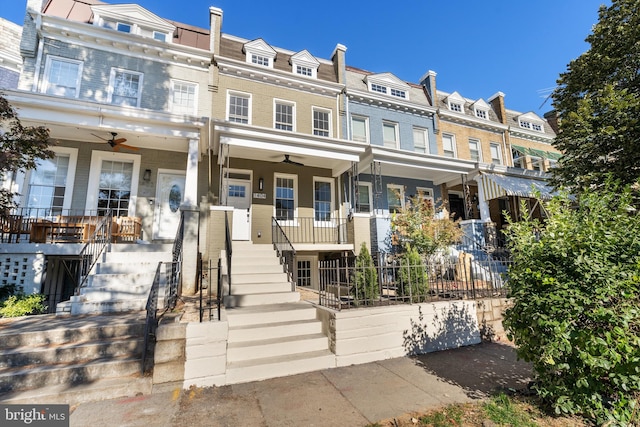 multi unit property featuring a porch and ceiling fan