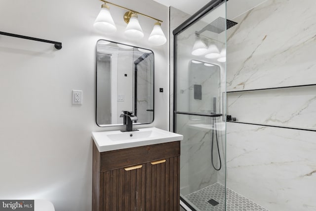 bathroom with vanity and a shower with door