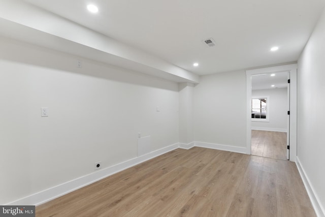 basement with light hardwood / wood-style flooring