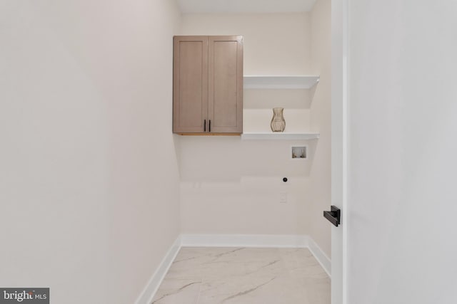 laundry area featuring hookup for an electric dryer, hookup for a washing machine, and cabinets