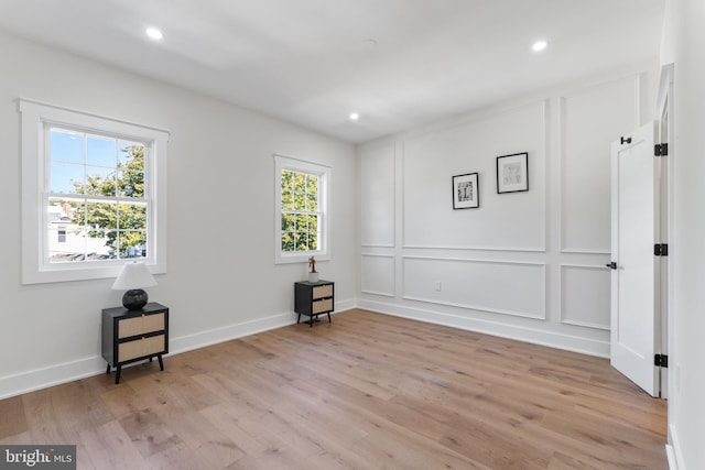 empty room featuring plenty of natural light and light wood-type flooring