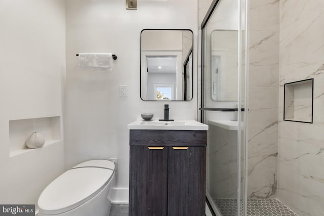 bathroom with toilet, walk in shower, and vanity