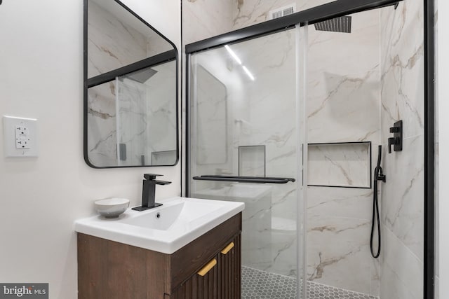 bathroom with vanity and a shower with shower door