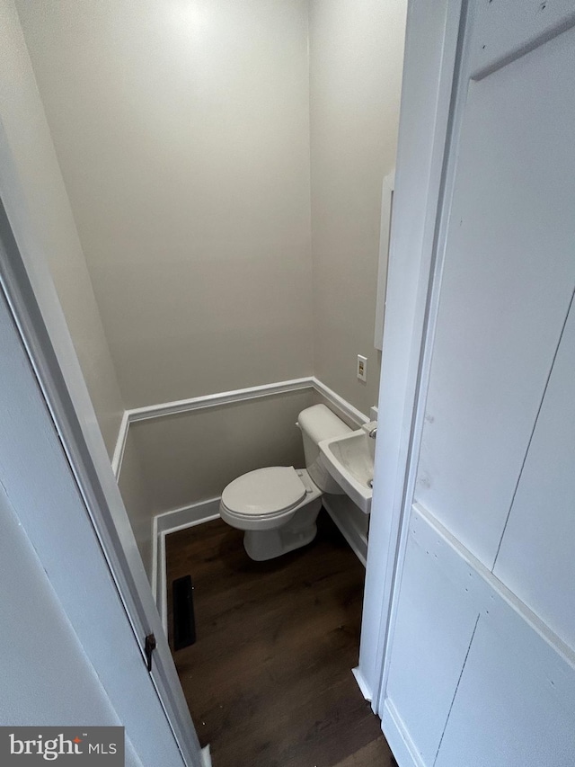 bathroom featuring toilet and wood finished floors