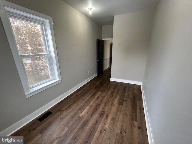 spare room featuring a healthy amount of sunlight, baseboards, and visible vents