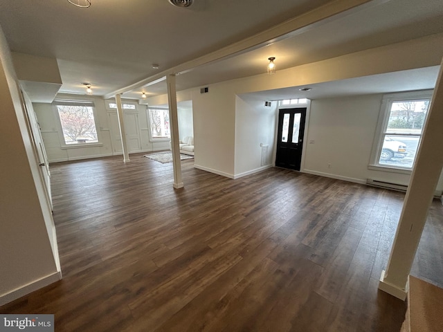 foyer with dark wood-style flooring, decorative columns, visible vents, and baseboards