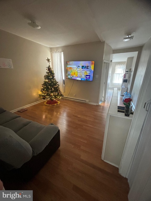 living room with hardwood / wood-style floors and a baseboard heating unit