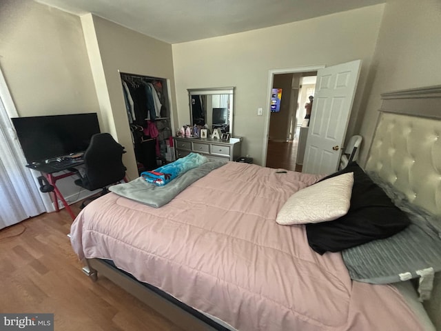 bedroom with light hardwood / wood-style flooring and a closet