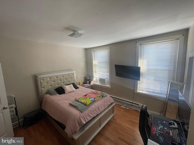 bedroom featuring a baseboard radiator and hardwood / wood-style floors