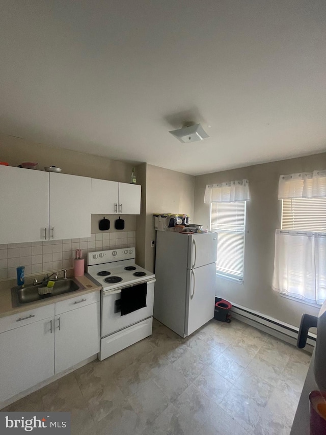 kitchen with white cabinets, backsplash, baseboard heating, sink, and white appliances