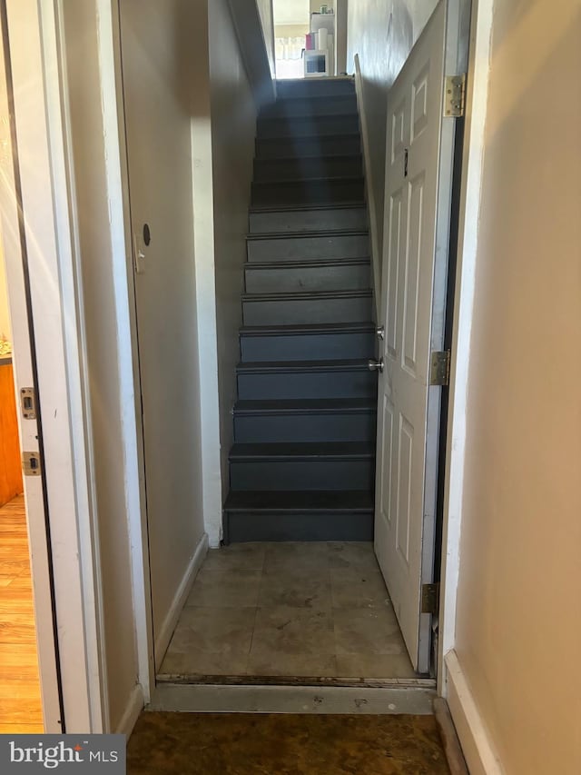 stairs featuring hardwood / wood-style flooring