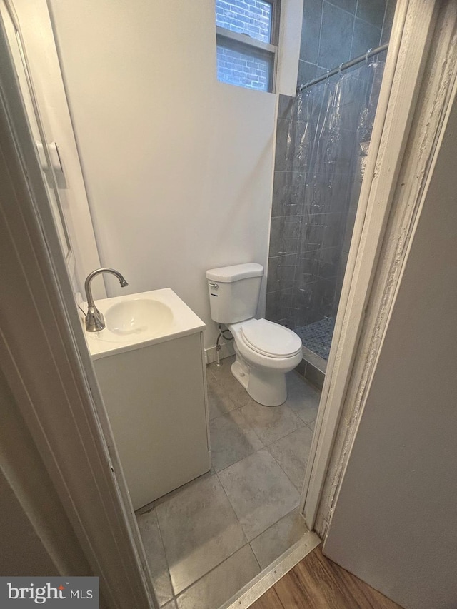 bathroom with vanity, hardwood / wood-style floors, a shower with curtain, and toilet