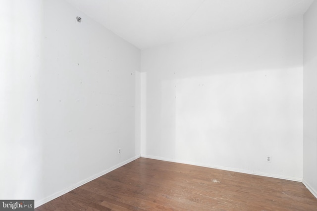 unfurnished room featuring hardwood / wood-style flooring