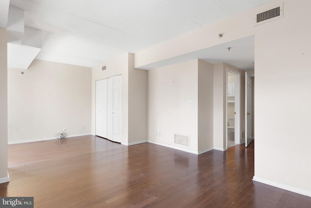 spare room with dark hardwood / wood-style floors