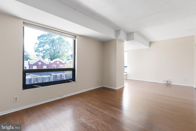 bonus room with a textured ceiling and wood-type flooring